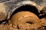 tire-stuck-in-mud_iStock_000019127825XSmall